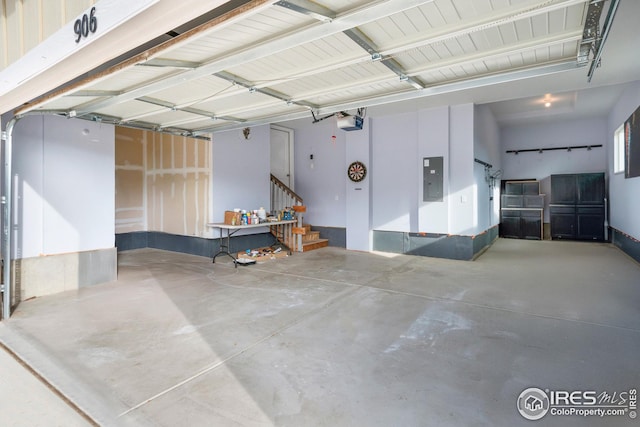 garage with a garage door opener and electric panel