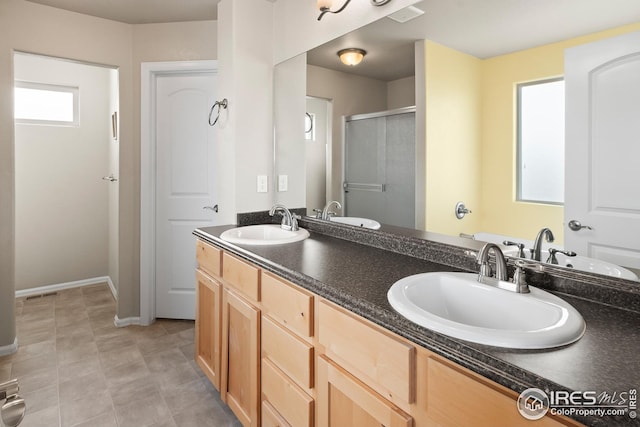 bathroom featuring a sink, visible vents, and a shower stall