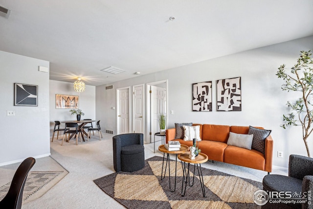 carpeted living area with visible vents and baseboards