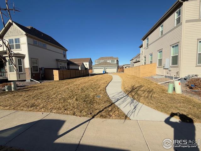 view of yard featuring a residential view and fence