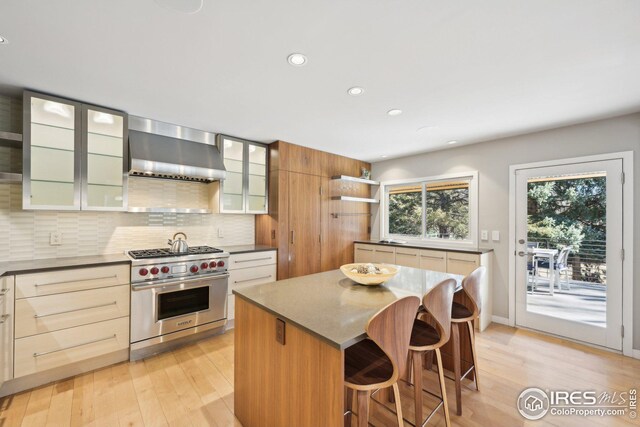 503 Kalmia Ave, Boulder, CO 80304 - kitchen with light wood-style floors, wall chimney range hood, designer range, decorative backsplash, and open shelves