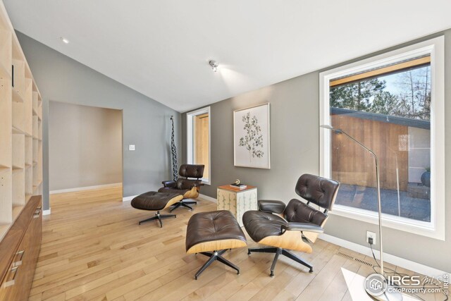 503 Kalmia Ave, Boulder, CO 80304 - living area featuring lofted ceiling, light wood-style flooring, and baseboards