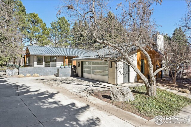 503 Kalmia Ave, Boulder, CO 80304 - view of front of home featuring metal roof, concrete driveway, a standing seam roof, and a garage