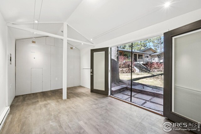 503 Kalmia Ave, Boulder, CO 80304 - interior space featuring baseboard heating, vaulted ceiling, and wood finished floors