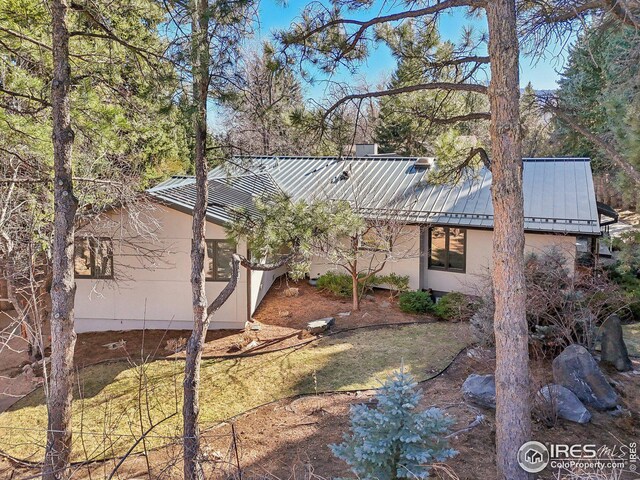 503 Kalmia Ave, Boulder, CO 80304 - rear view of house featuring a standing seam roof, metal roof, and stucco siding