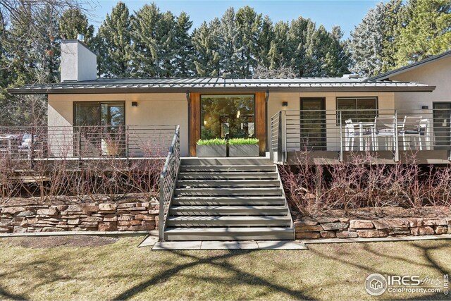 503 Kalmia Ave, Boulder, CO 80304 - mid-century inspired home featuring a standing seam roof, metal roof, stairway, and stucco siding