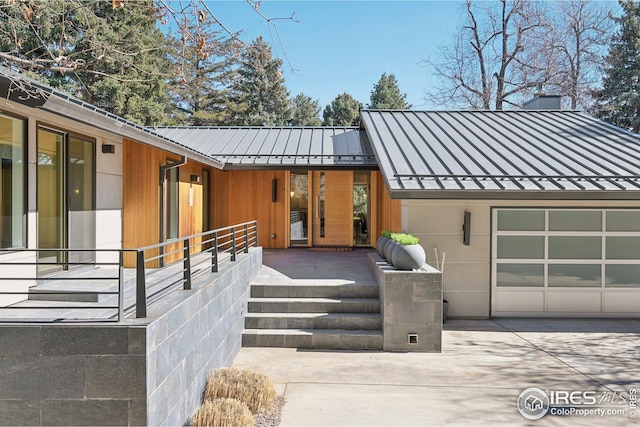 503 Kalmia Ave, Boulder, CO 80304 - view of front of house with a garage, a standing seam roof, metal roof, and concrete driveway
