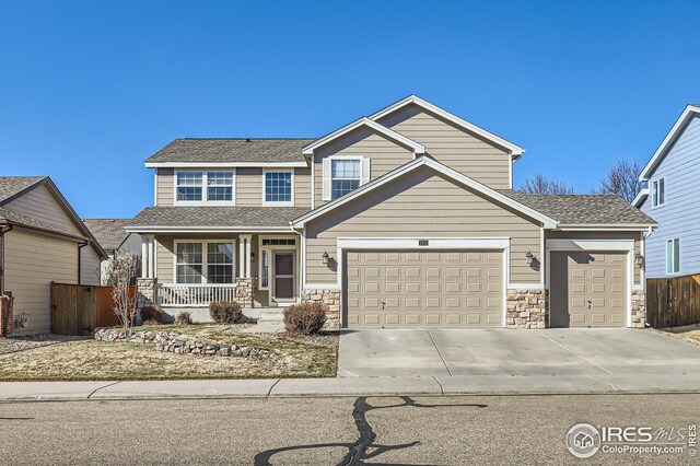 view of front facade featuring driveway, a porch, and an attached garage