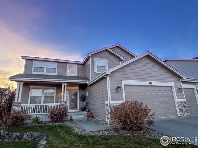 view of front of house featuring covered porch, concrete driveway, and an attached garage