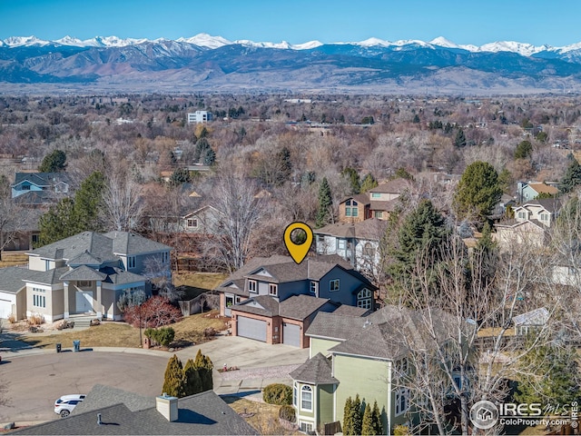 drone / aerial view featuring a residential view and a mountain view