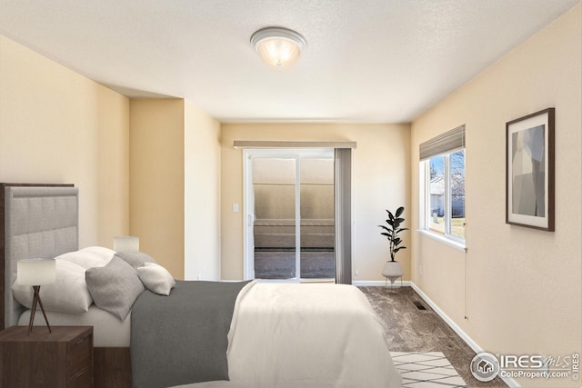 carpeted bedroom featuring visible vents and baseboards