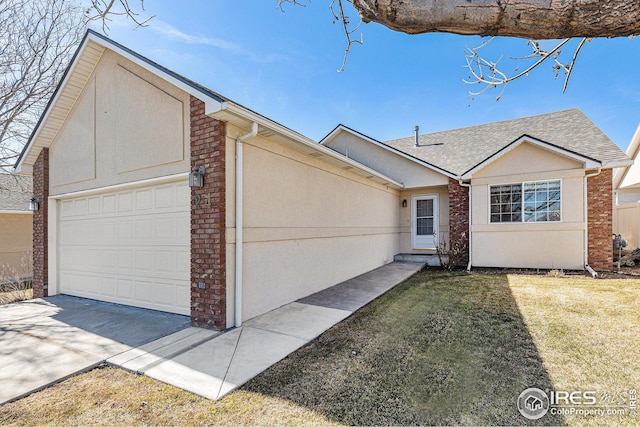 single story home featuring a garage, driveway, stucco siding, a front lawn, and brick siding