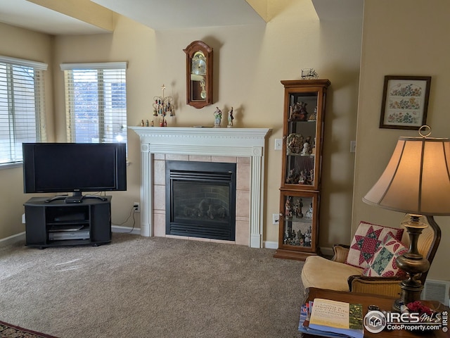 living room featuring a fireplace, carpet flooring, and baseboards