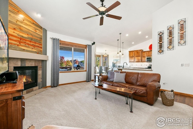 living area featuring lofted ceiling, a ceiling fan, recessed lighting, and baseboards