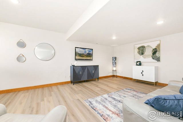 living area with wood finished floors, recessed lighting, and baseboards