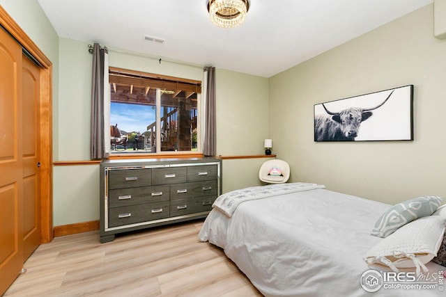 bedroom with visible vents, baseboards, and light wood-type flooring