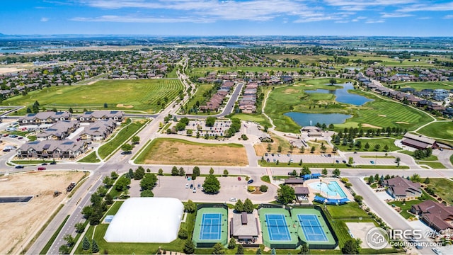 drone / aerial view featuring a water view and a residential view