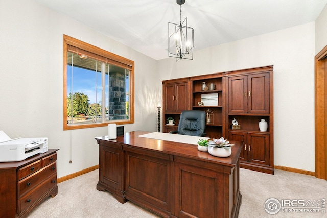 office featuring a notable chandelier, light colored carpet, and baseboards