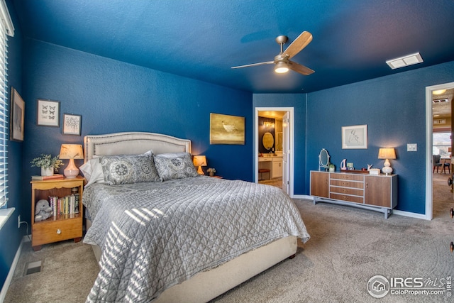 bedroom with baseboards, carpet floors, visible vents, and a ceiling fan