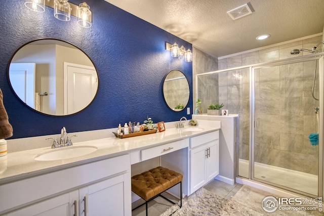 full bath with a stall shower, visible vents, and a sink