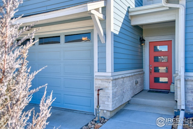 view of exterior entry with a garage