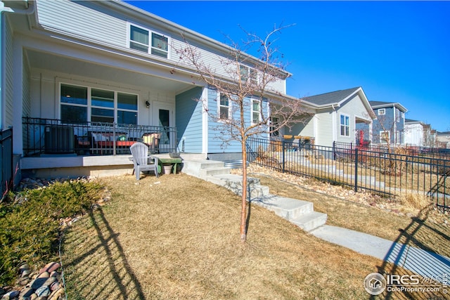 view of front of home with fence and a porch