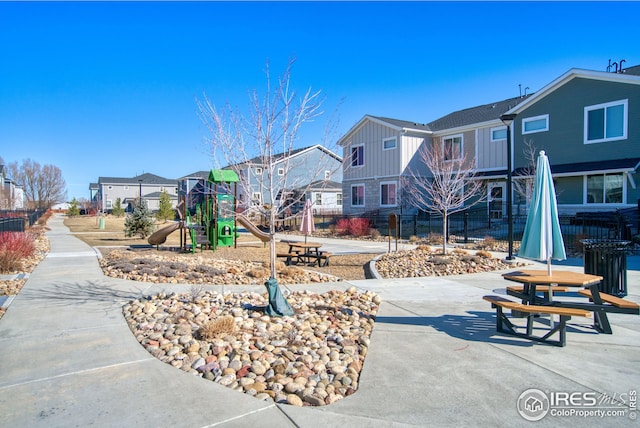 community jungle gym featuring fence and a residential view