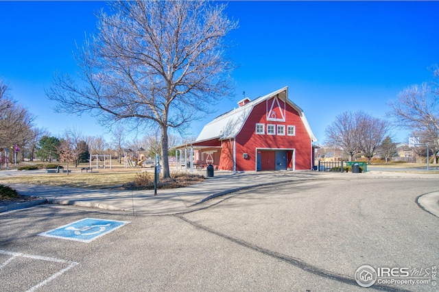 view of building exterior with a garage and a barn