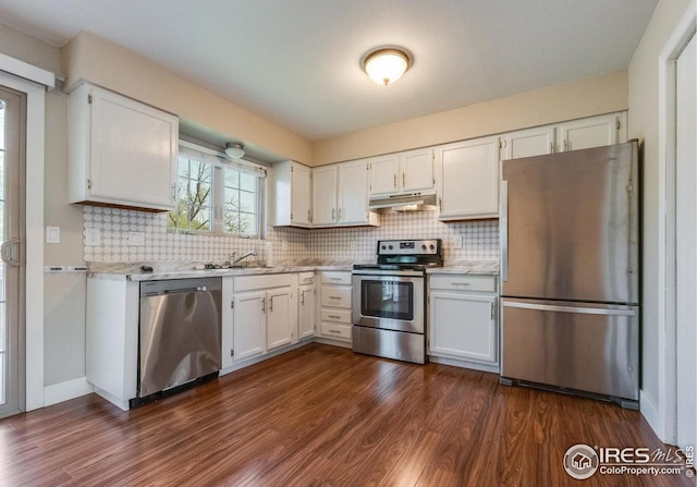 kitchen featuring white cabinets, under cabinet range hood, and stainless steel appliances