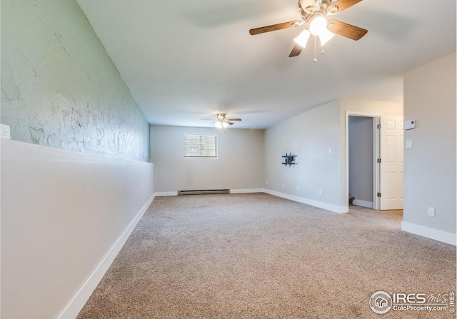 carpeted empty room with a ceiling fan, baseboards, and baseboard heating