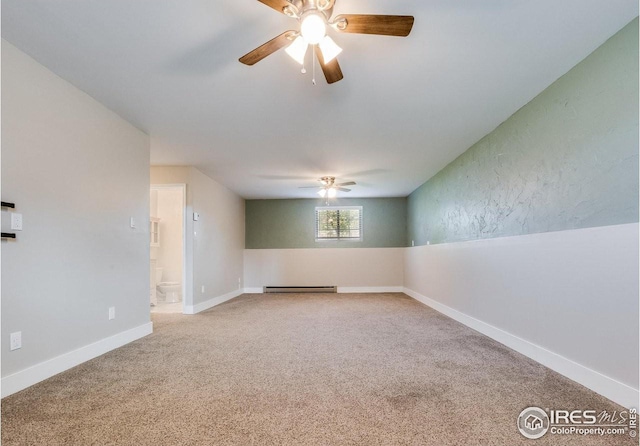 spare room with ceiling fan, baseboard heating, carpet flooring, and baseboards