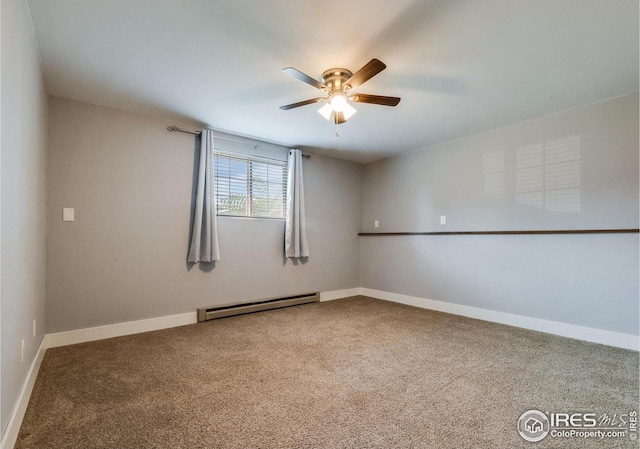 carpeted spare room with a baseboard heating unit, ceiling fan, and baseboards