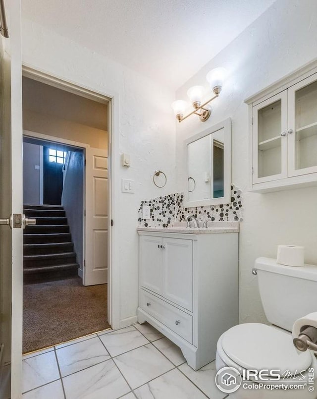 bathroom featuring vanity and toilet