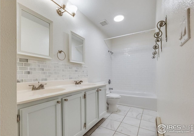 full bath with toilet, marble finish floor, visible vents, and a sink