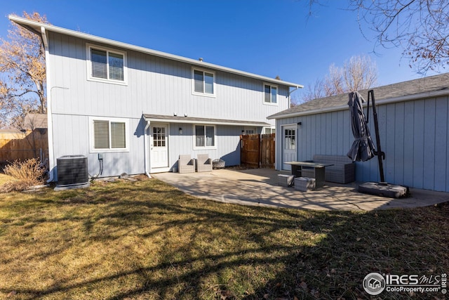 back of property with cooling unit, fence, a patio, and a lawn