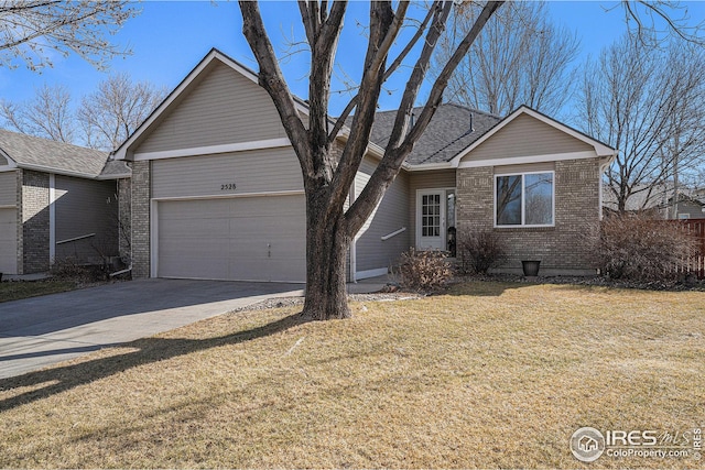 ranch-style home with a garage, driveway, a front yard, and brick siding