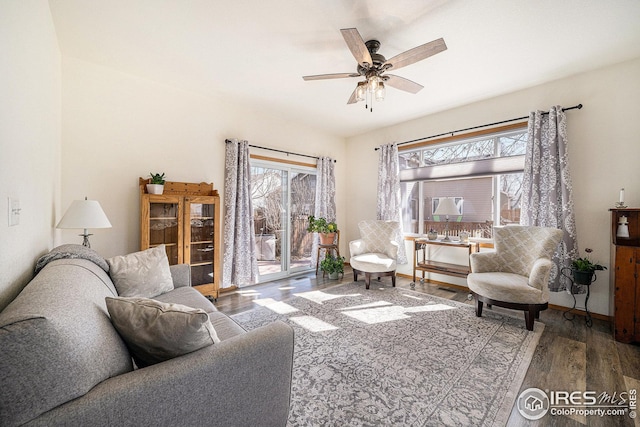 living area with ceiling fan, wood finished floors, and baseboards