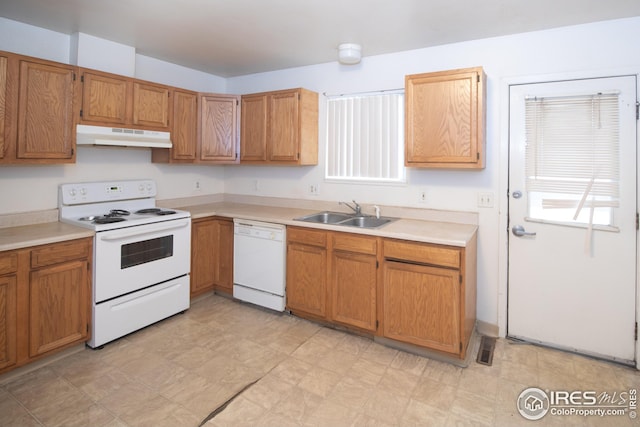 kitchen featuring light floors, light countertops, a sink, white appliances, and under cabinet range hood