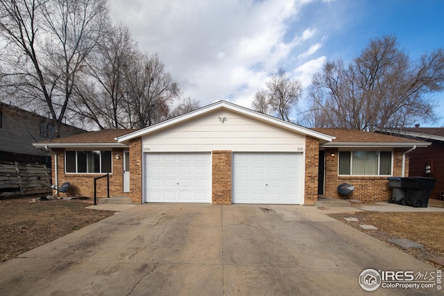 ranch-style house with a garage, concrete driveway, and brick siding