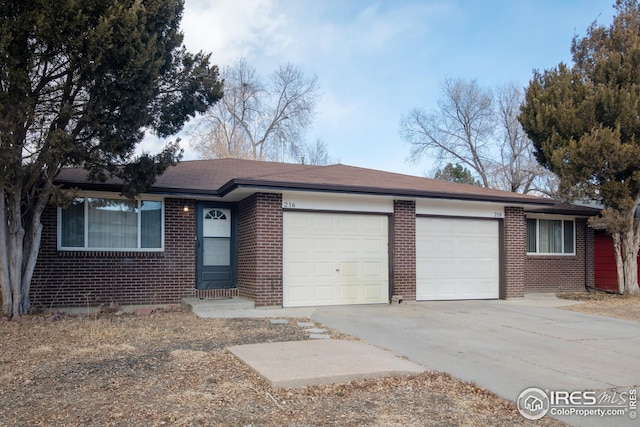 ranch-style home with concrete driveway, brick siding, and an attached garage