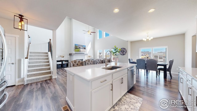 kitchen with white cabinets, dishwasher, dark wood-style flooring, light countertops, and a sink