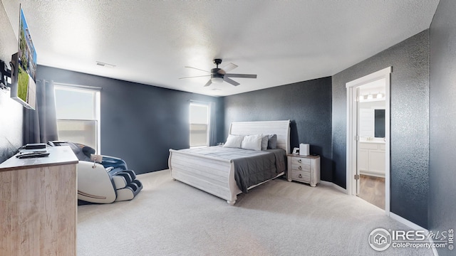 bedroom featuring carpet, visible vents, a textured ceiling, and a textured wall