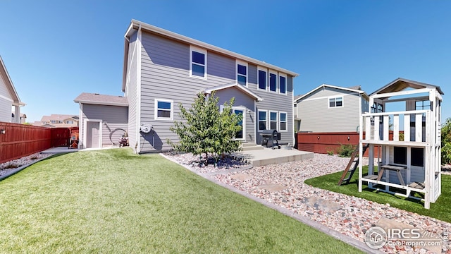 rear view of house featuring a yard, a patio area, and fence