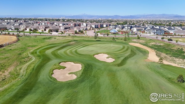 view of home's community featuring a residential view, view of golf course, and a mountain view