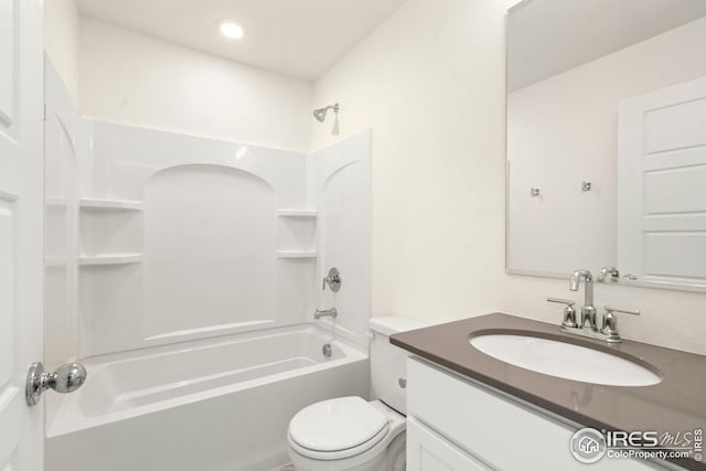 bathroom featuring toilet, vanity, and shower / bathing tub combination