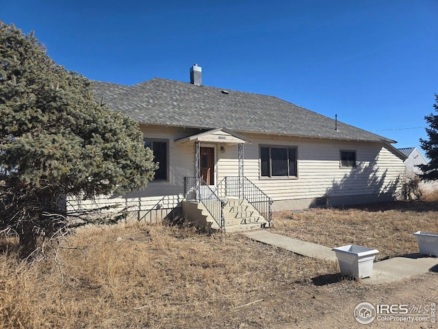 view of front of home featuring roof with shingles