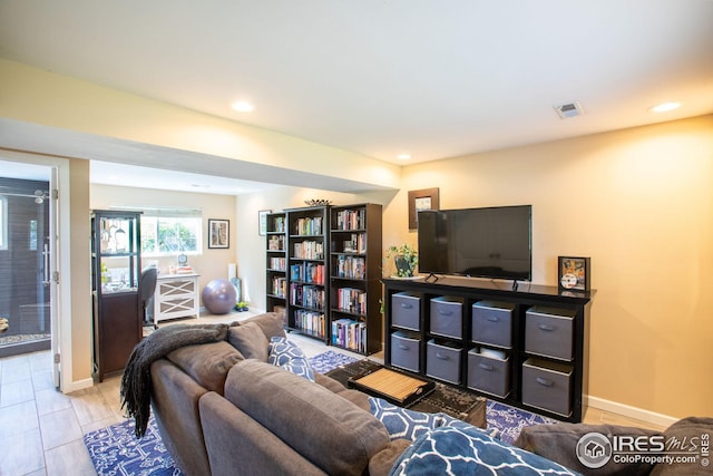 living room with recessed lighting, visible vents, and baseboards