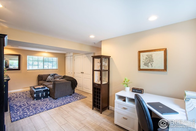 office featuring recessed lighting, light wood-style flooring, and baseboards