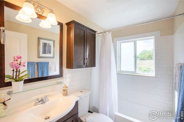 full bathroom featuring toilet, shower / bath combination with curtain, backsplash, and vanity