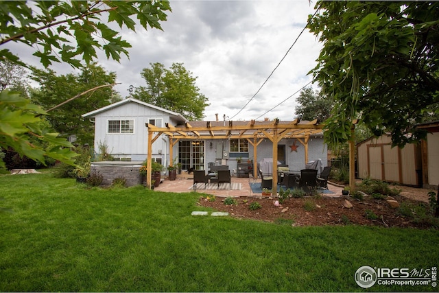 back of house with a pergola, a yard, an outdoor structure, a patio area, and board and batten siding